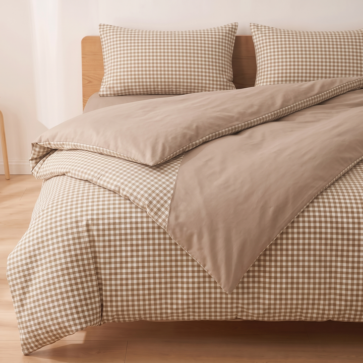 Cotton Duvet Cover Set in Beige Gingham – angled bed corner with diagonal fold revealing plain reverse