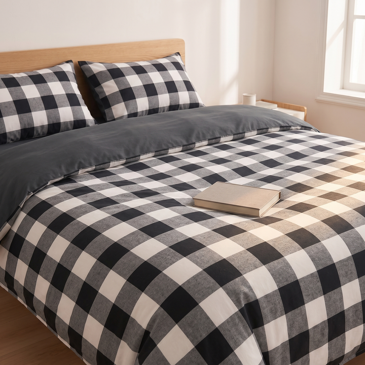 Cotton Duvet Cover Set in Black Buffalo Check – with a closed book resting on top of the bed