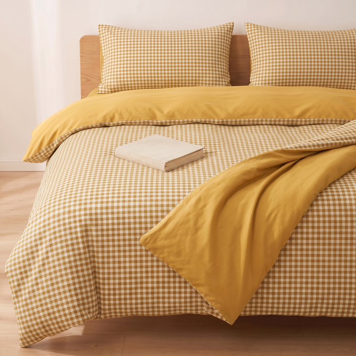 Cotton Duvet Cover Set in Mustard Gingham – tightly cropped front view, reverse side flipped across the bed