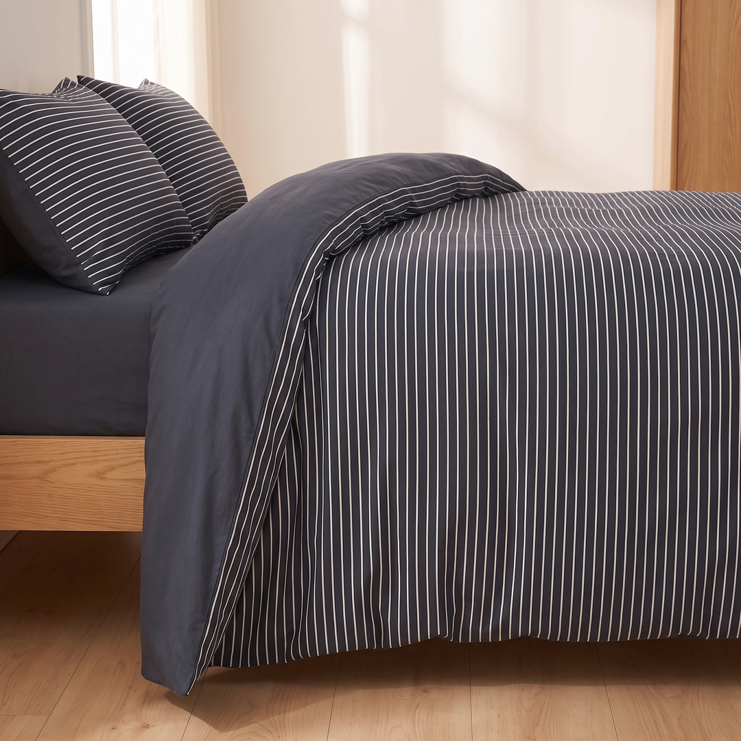 Cotton Duvet Cover Set in Navy Stripe – side-on view of oak bed frame with duvet turned back