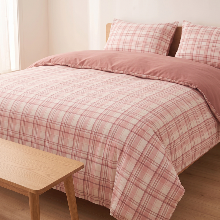 Cotton Duvet Cover Set in Pink Plaid – made bed seen past a wooden bench in the foreground