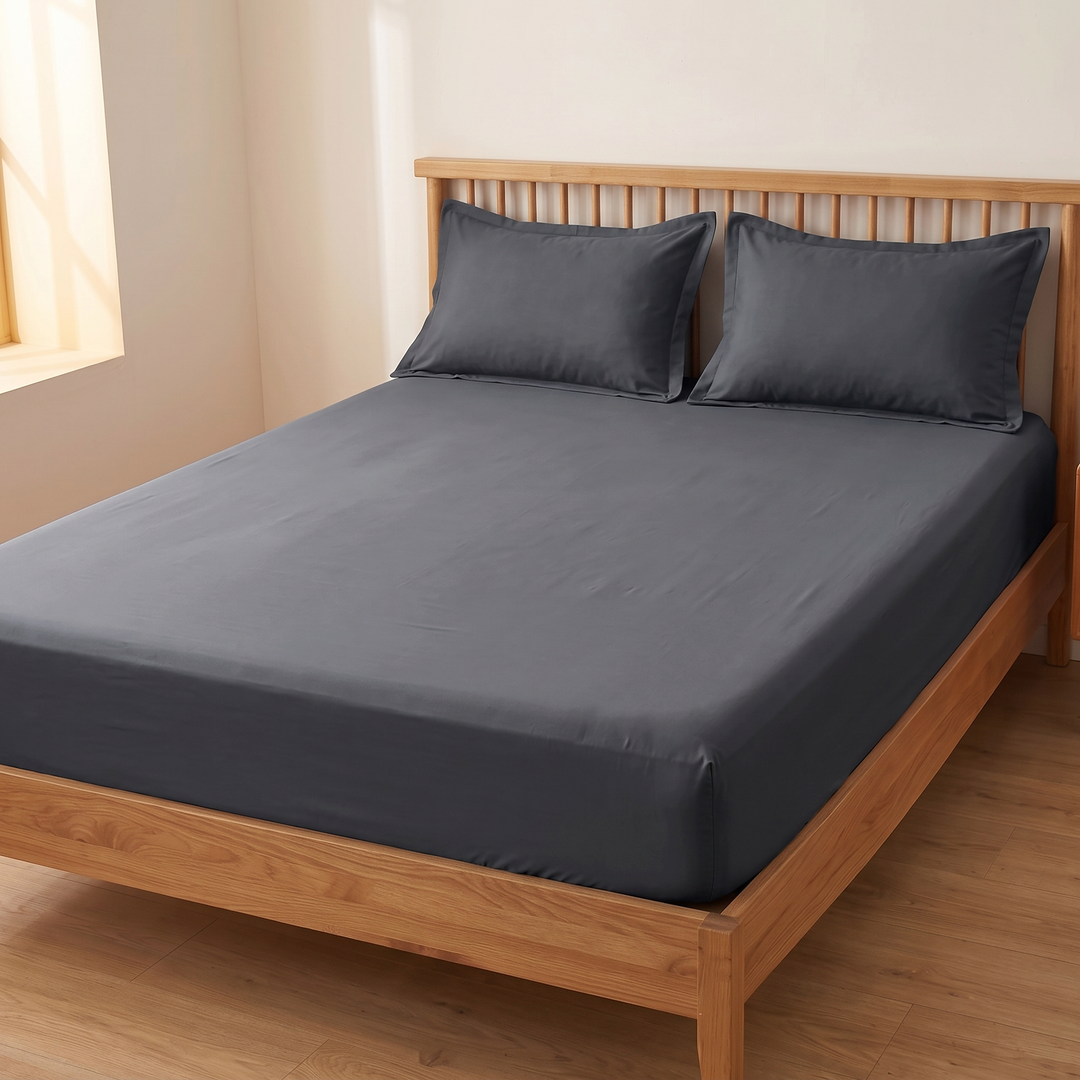 Cotton Fitted Sheet Set with 2 Pillowcases in Dark Gray – sheet stretched across full mattress, seen from foot corner