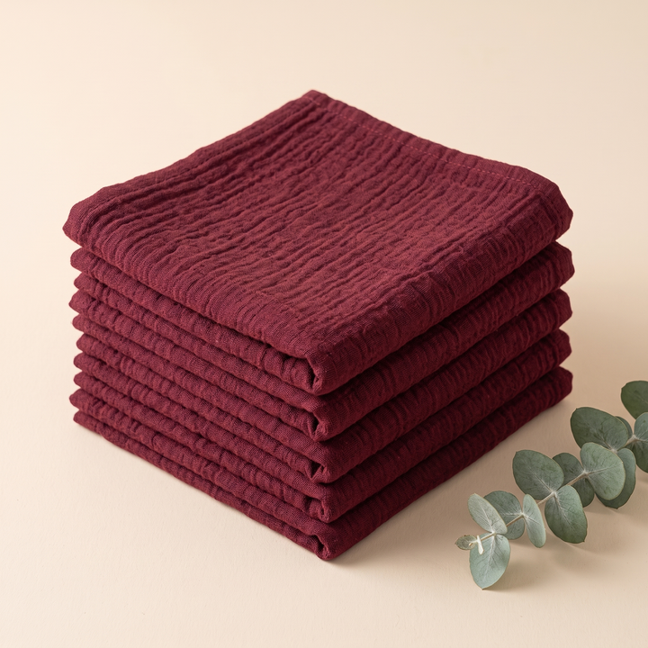 Cotton Gauze Napkins – Set of 6 in Burgundy – neat stack beside a eucalyptus sprig on a plain backdrop