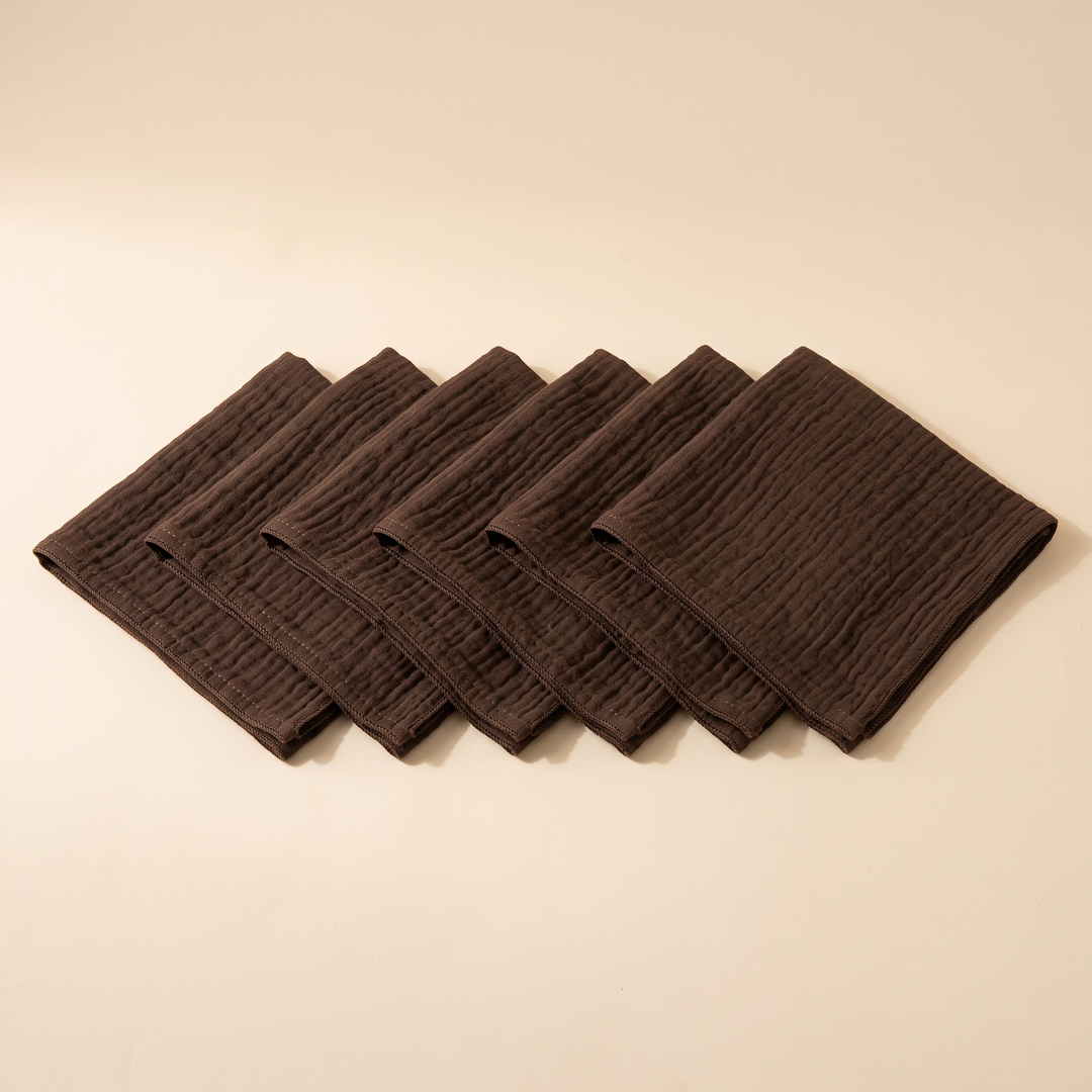 Cotton Gauze Napkins – Set of 6 in Dark Brown – evenly staggered diagonal line seen from above on plain studio backdrop