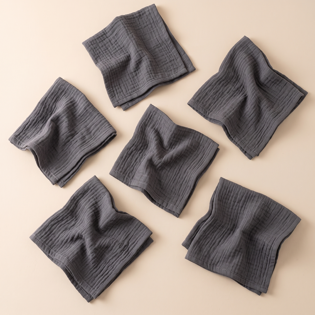 Cotton Gauze Napkins – Set of 6 in Dark Gray – scattered at varied angles with space between, overhead view