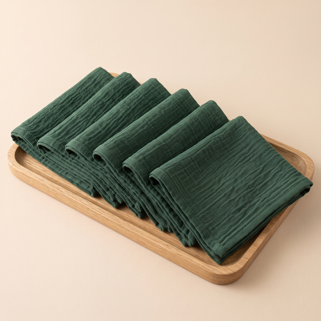 Cotton Gauze Napkins – Set of 6 in Hunter Green – overlapping in a row on a light wooden tray