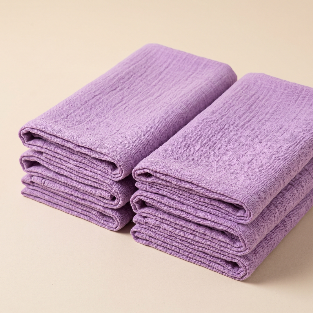 Cotton Gauze Napkins – Set of 6 in Lilac – folded edges facing camera in two parallel piles, cream backdrop