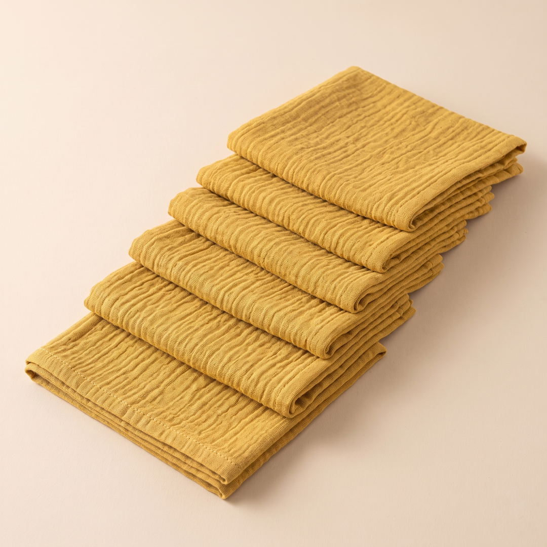 Cotton Gauze Napkins – Set of 6 in Mustard – overlapping diagonal row, three-quarter angle, stitched hem at front
