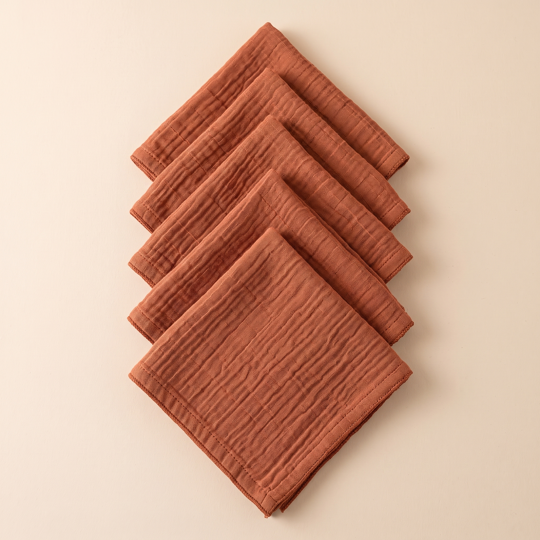 Cotton Gauze Napkins – Set of 6 in Rust – diamond-turned folded squares cascading in a vertical overlap