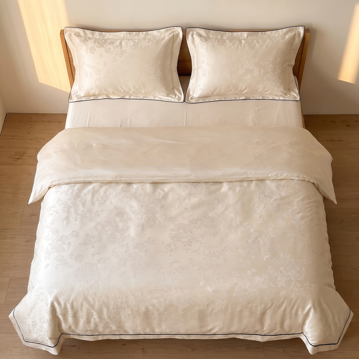 Cotton Jacquard Bedding Set in Champagne Piped Blossom – directly overhead view of made bed on light wood floor