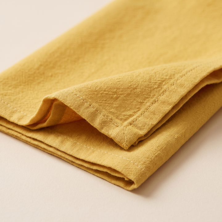 Cotton Cloth Napkins – Set of 24 in Golden Yellow – close-up of a folded corner showing the stitched hem