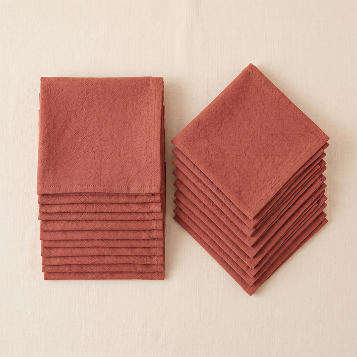 Cotton Cloth Napkins – Set of 24 in Rust – one stack set square beside another turned diagonally, seen from above