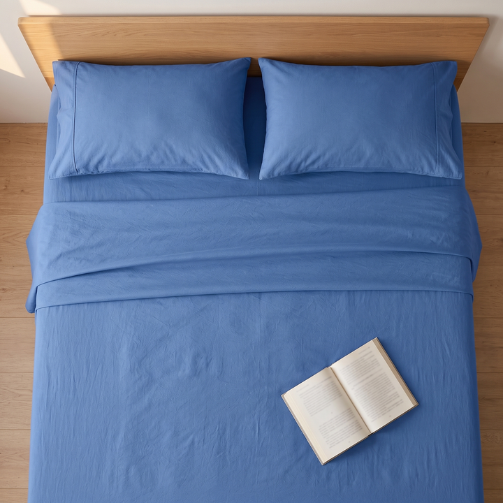 Cotton Flat Sheet Set – Percale, with 2 Pillowcases in Blue – open book resting on the sheet, seen from above