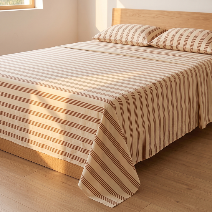Cotton Flat Sheet Set – Percale, with 2 Pillowcases in Brown Stripe – angled view with window light casting shadows across the stripes