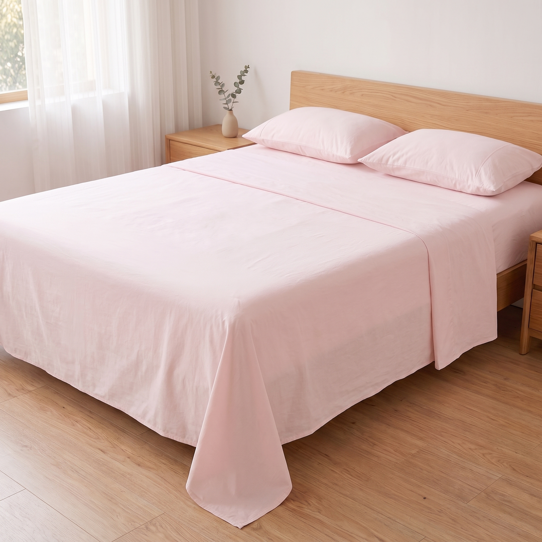 Cotton Flat Sheet Set – Percale, with 2 Pillowcases in Light Pink – side view with eucalyptus sprig in small vase on nightstand