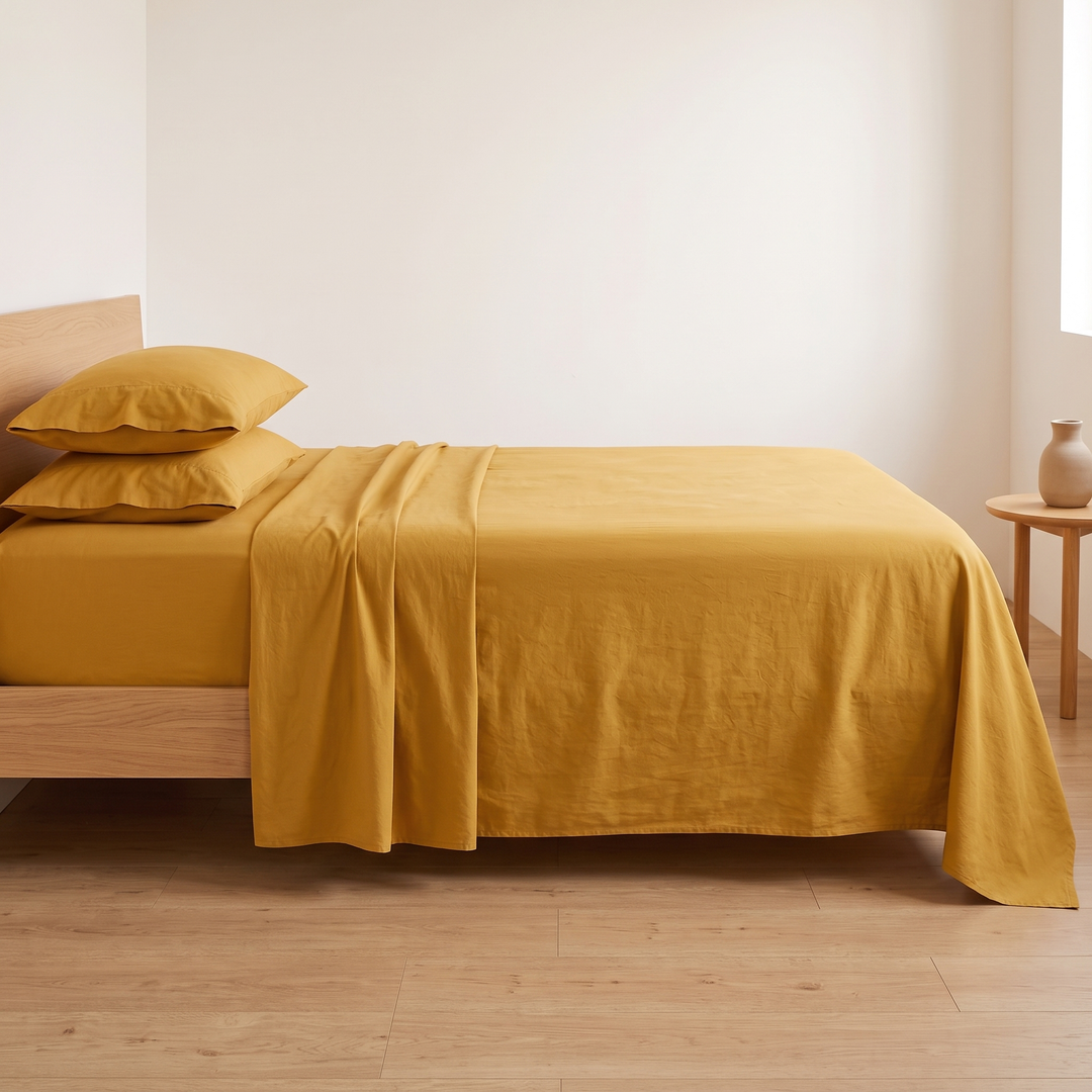 Cotton Flat Sheet Set – Percale, with 2 Pillowcases in Mustard – straight-on side view against a plain white wall