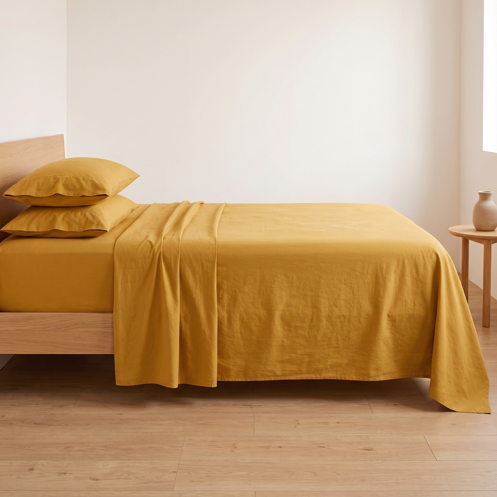 Cotton Flat Sheet Set – Percale, with 2 Pillowcases in Mustard – straight-on side view against a plain white wall