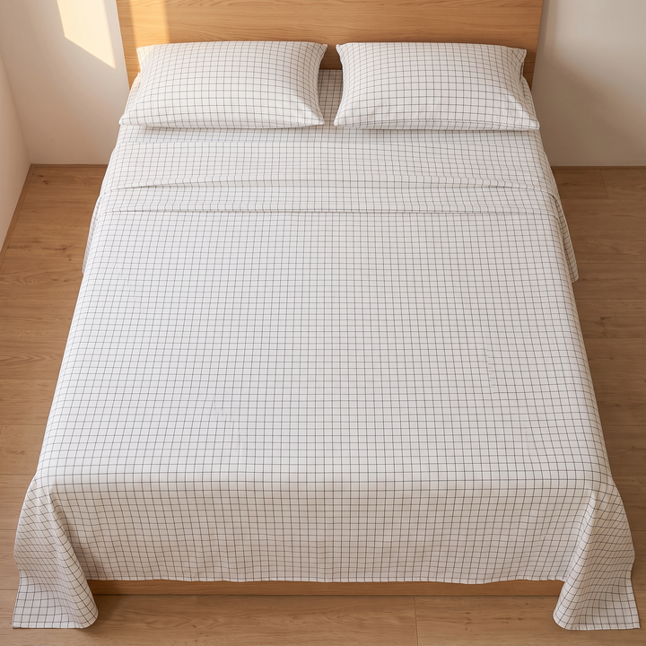 Cotton Flat Sheet Set – Percale, with 2 Pillowcases in White Grid – top-down view smoothed flat across a bed, pillows at headboard