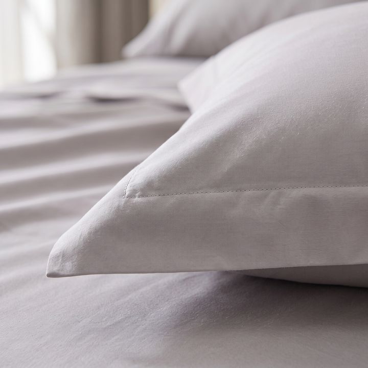 Cotton Sateen Pillowcases – Set of 2 in Gray – close-up of stitched hem corner on a made bed