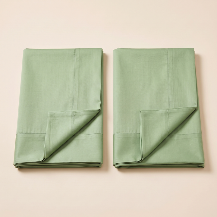 Cotton Sateen Pillowcases – Set of 2 in Light Green – overhead view of pair side by side with turned-back corners