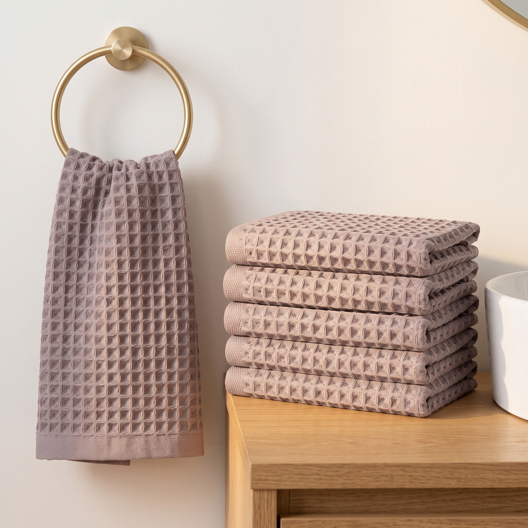 Cotton Waffle Hand Towels – Set of 6 in Taupe – one hung on a brass ring beside a stack on a wooden shelf