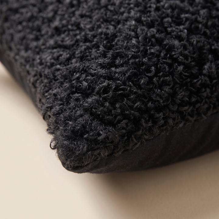 Curly Faux Fur Pillow Cover in Black – close-up of one corner showing curly texture and seam