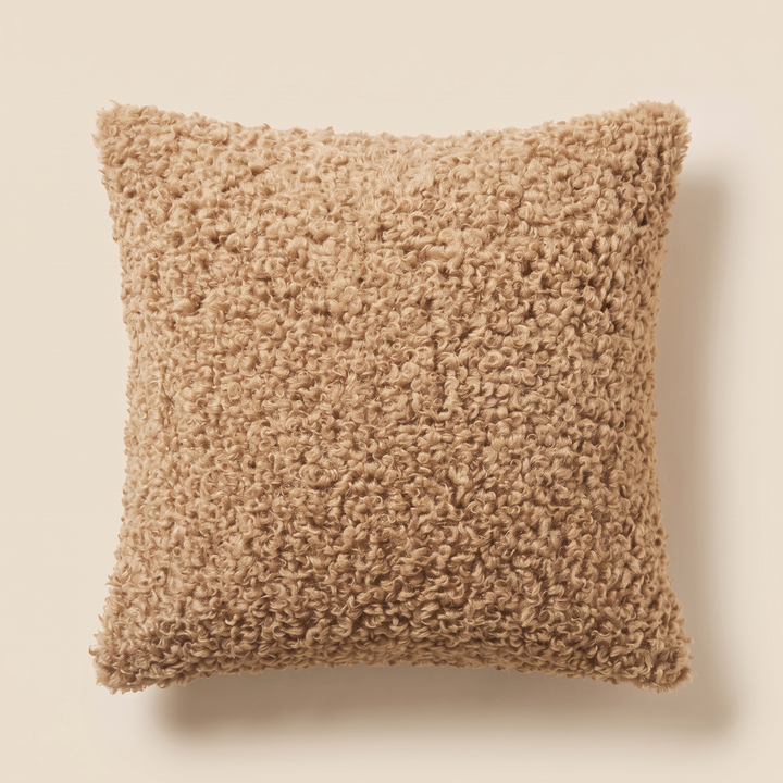 Curly Faux Fur Pillow Cover in Sand – lying flat from above with shadow falling to the right