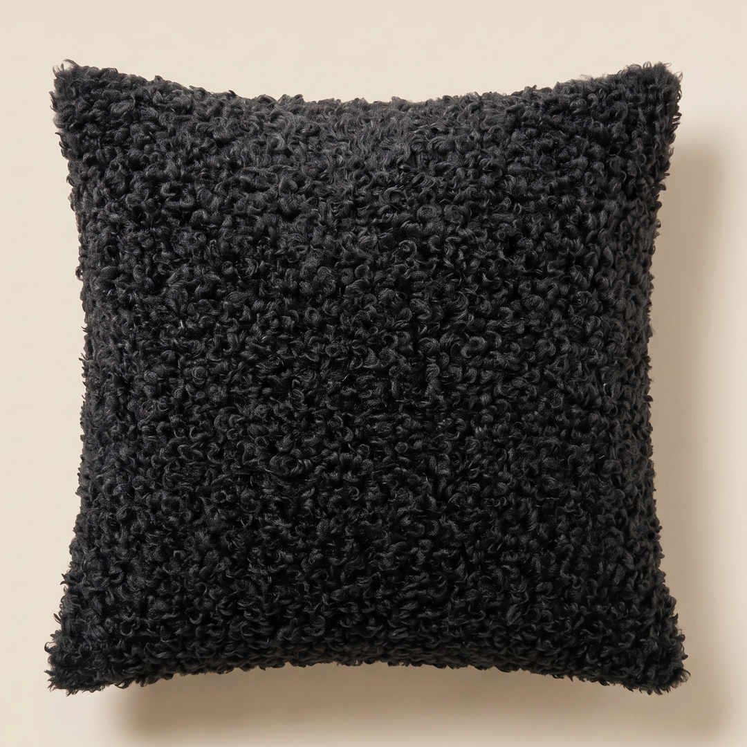 Curly Faux Fur Pillow Cover in Black – front view, flat against a plain cream background