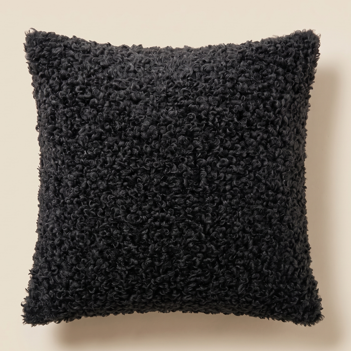 Curly Faux Fur Pillow Cover in Black – front view, flat against a plain cream background