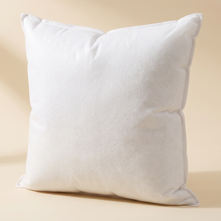 Throw Pillow Insert in White – standing upright against a plain cream backdrop, front view