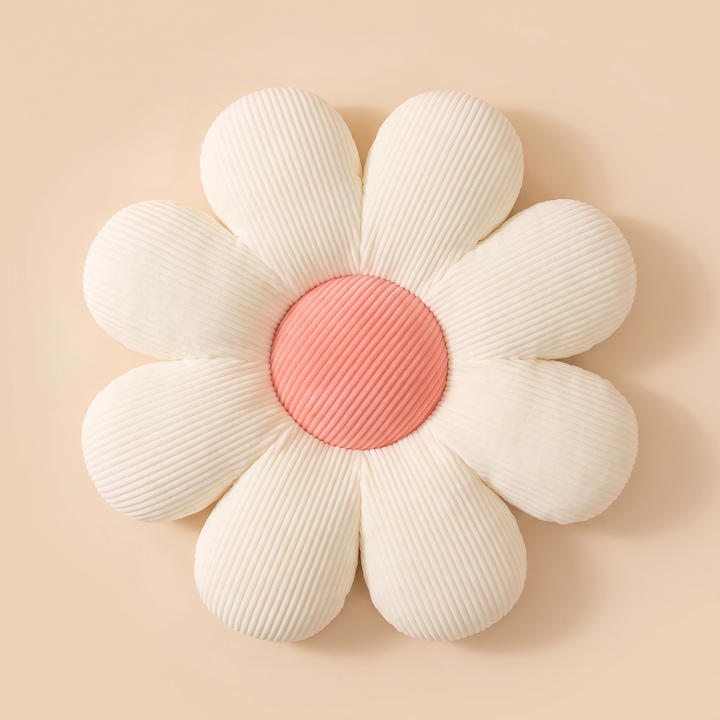 Daisy Flower Pillow in Cream – overhead flat lay on a soft peach surface