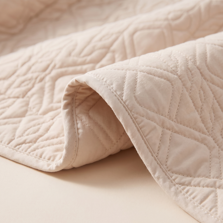 Close-up of the diamond quilting and stitched edge