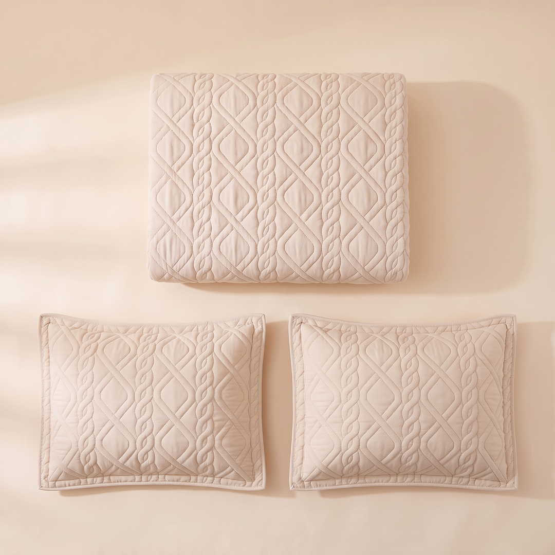 Diamond quilted bedspread folded with its 2 pillow shams