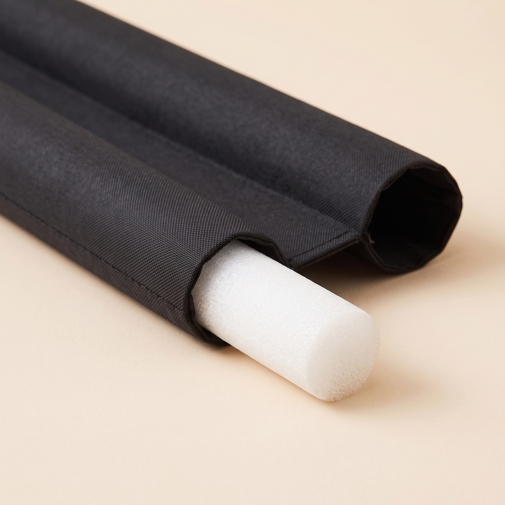 Door Draft Stopper – Twin Tube, Under-Door in Black – close-up of white foam insert sliding out of fabric tube end