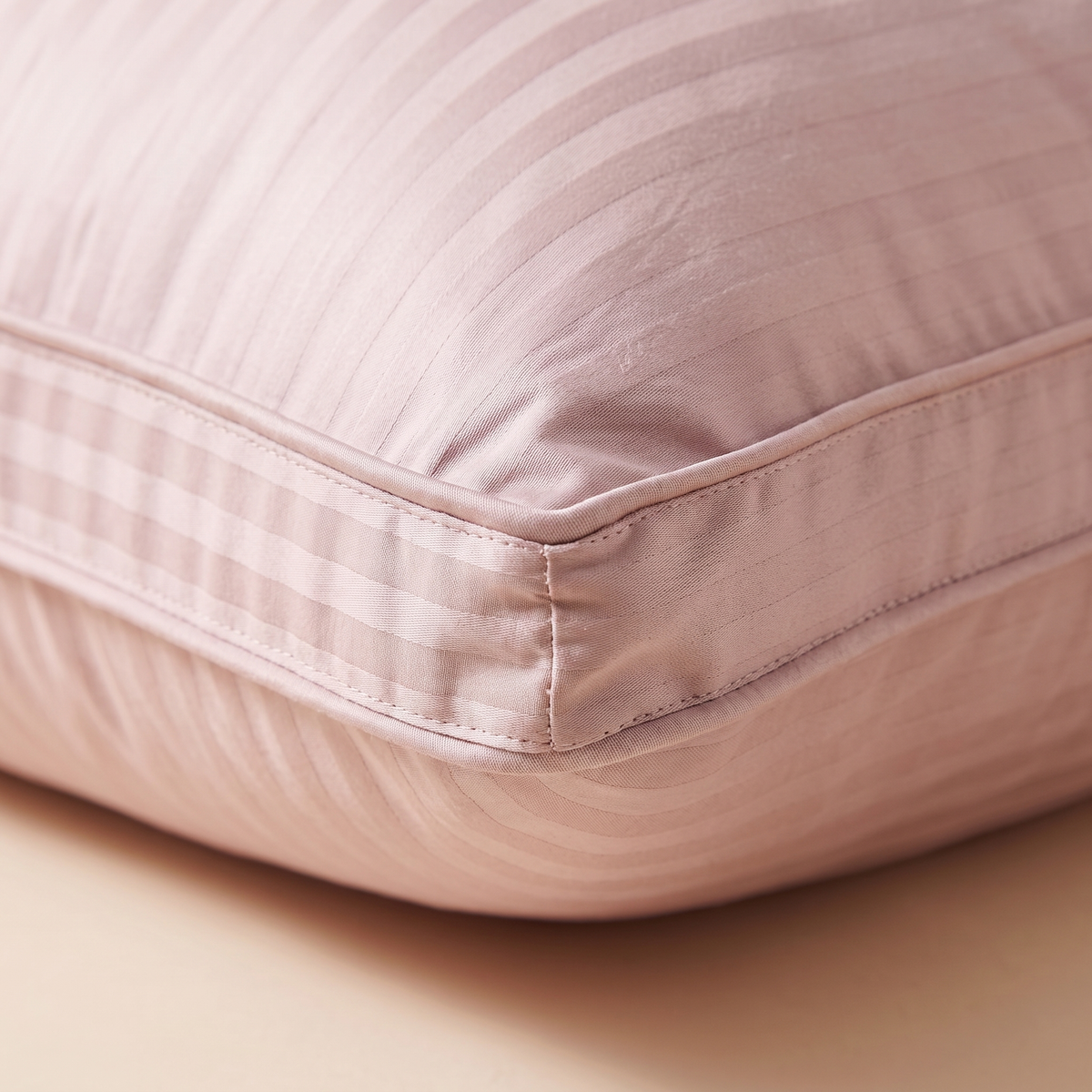 Goose Down and Feather Pillow in Dusty Pink – close-up of the striped fabric and stitched corner seam