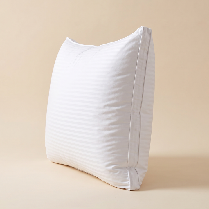 Goose Down and Feather Pillow in White – side profile standing upright showing the piped edge and depth