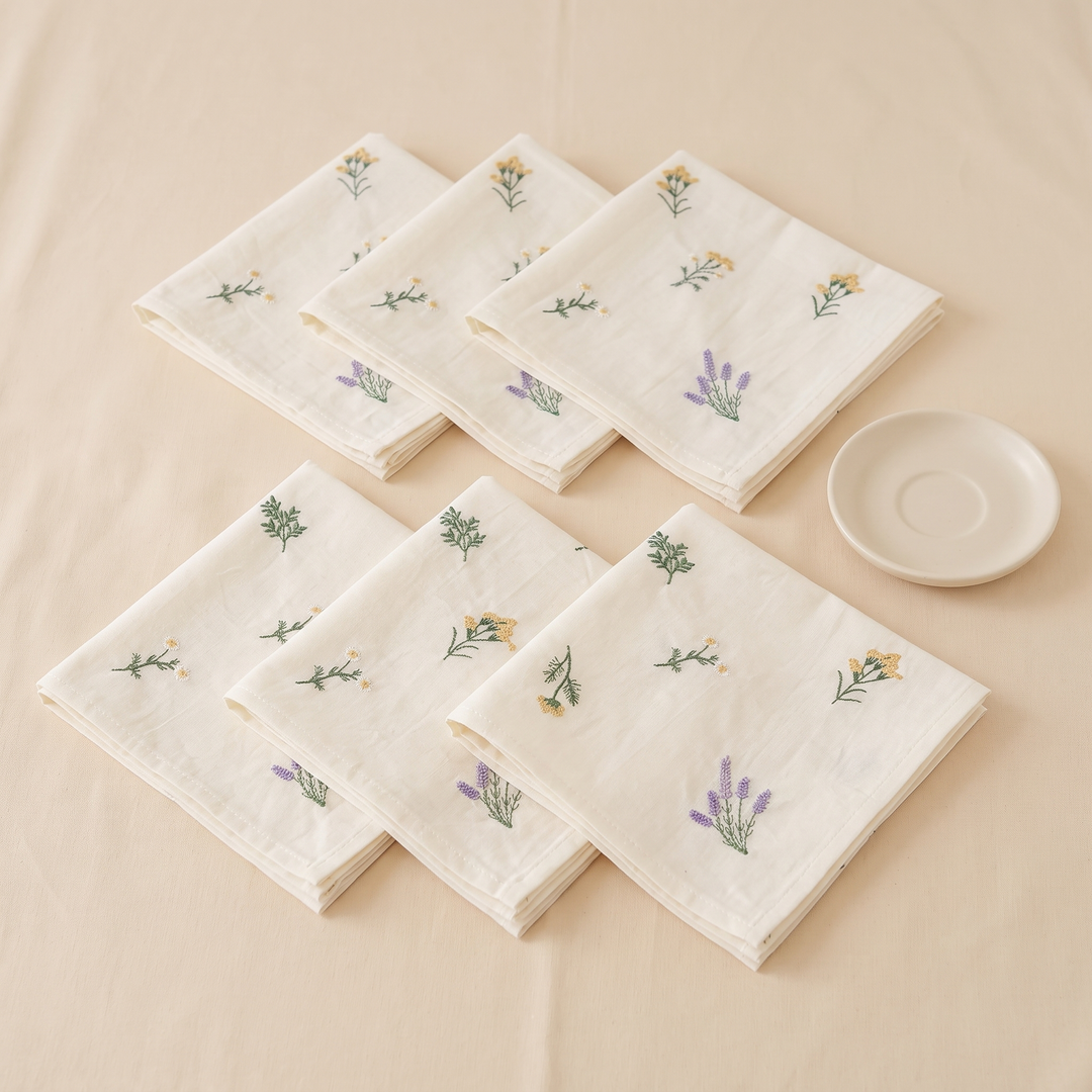 Embroidered Cotton Napkins – Set of 6 in Cream – Meadow Sprig – napkins laid in two rows of three beside a saucer