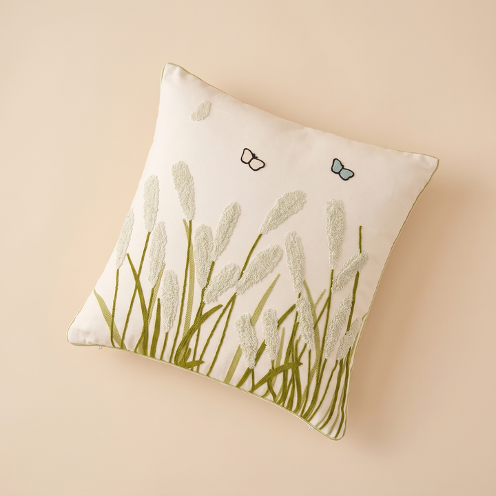 Embroidered Botanical Pillow Cover in Cream – Sage Reed Grass – flat lay from above, set diagonally on a plain peach surface