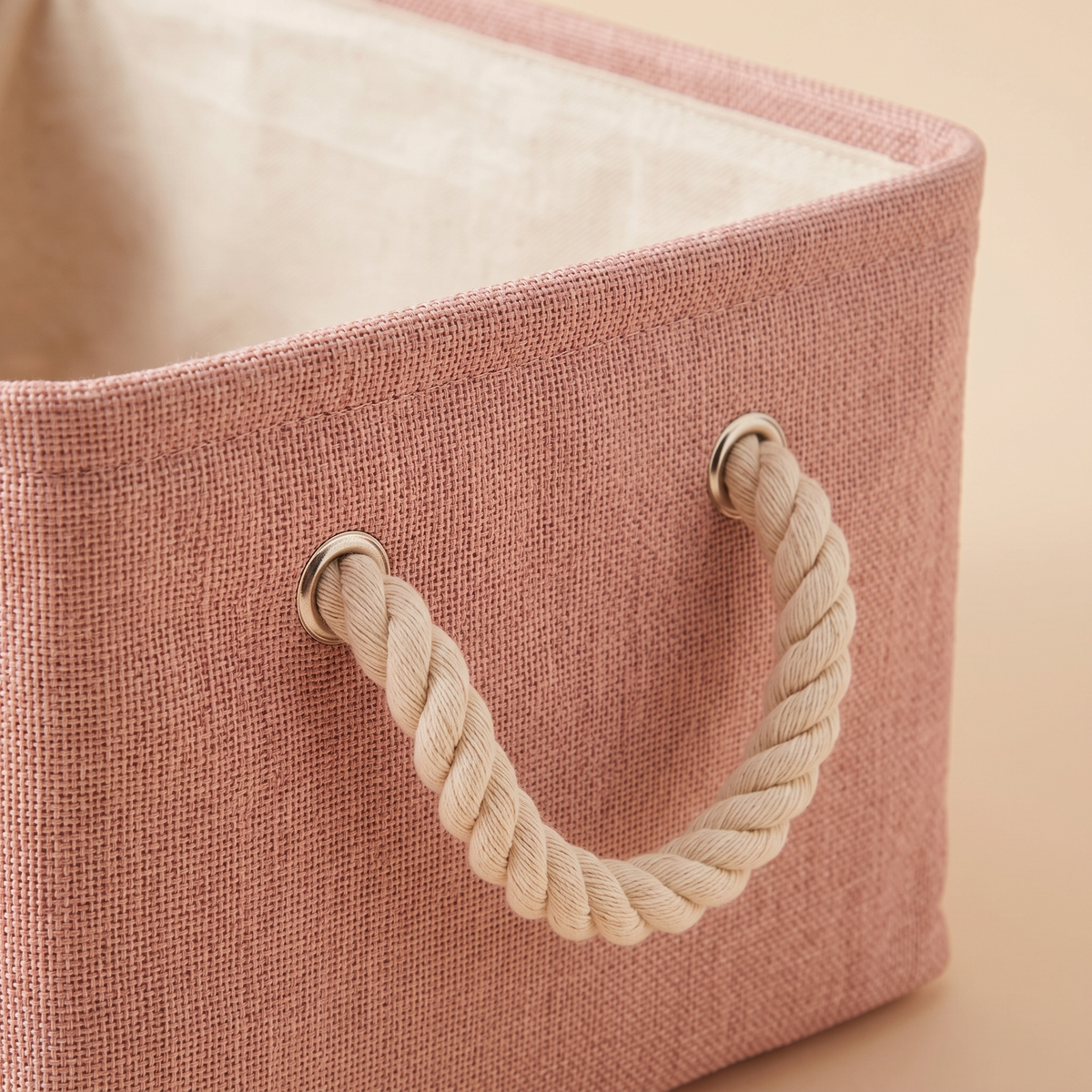 Foldable Fabric Storage Bin with Handles in Dusty Pink – close-up of woven texture and rope handle with metal eyelet