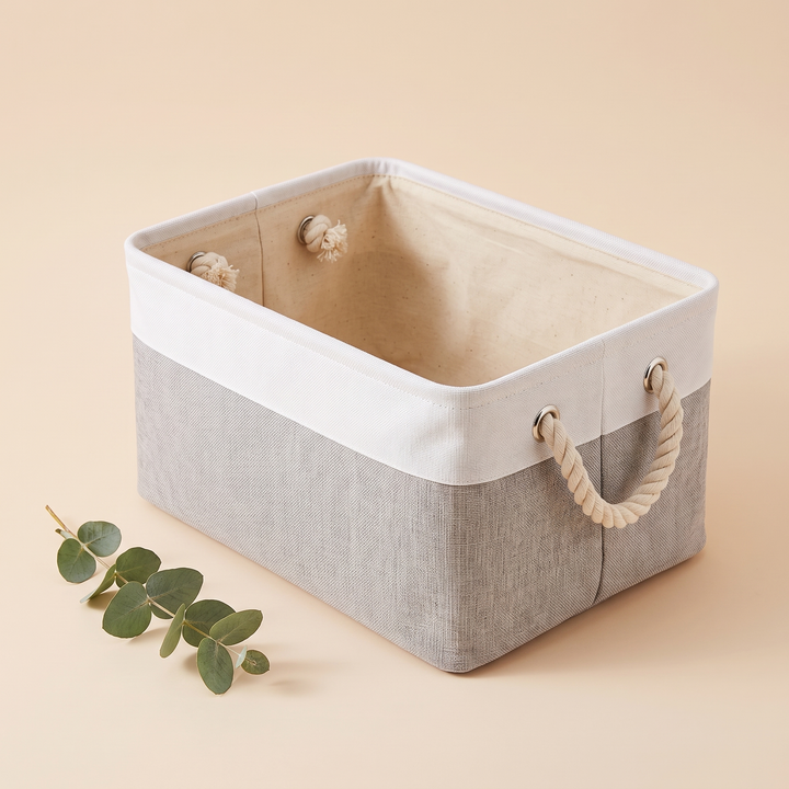 Foldable Fabric Storage Bin with Handles in White &amp; Gray – with a small eucalyptus sprig resting beside it