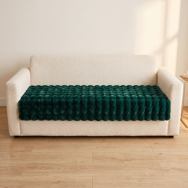 Faux Fur Couch Cover – Plush Bubble Pad in Dark Green – front-facing view across a boucle sofa seat against a plain wall