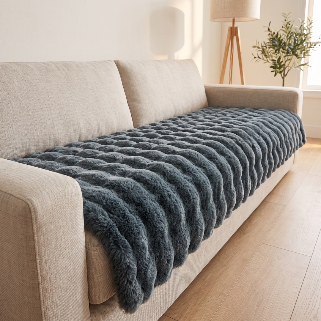Faux Fur Couch Cover – Plush Bubble Pad in Slate Blue – low angle along a sofa with olive plant behind