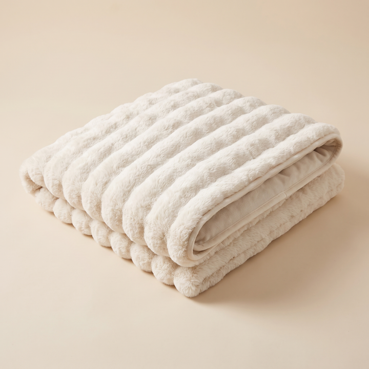 Faux Fur Couch Cover – Plush Bubble Pad in Cream – folded in a neat stack on a plain beige background