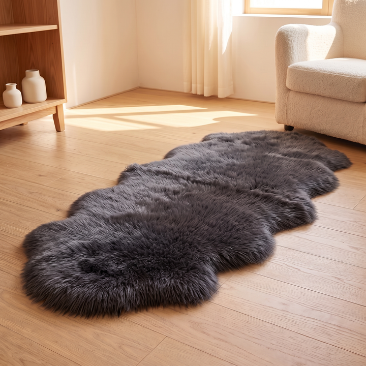 Shaggy Faux Sheepskin Rug in Dark Gray – beside a cream boucle armchair in a sunny corner