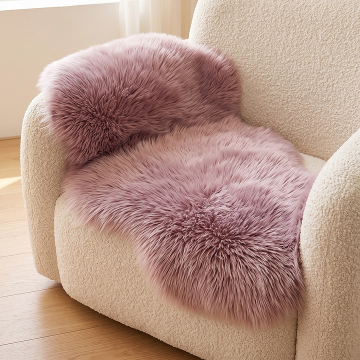 Shaggy Faux Sheepskin Rug in Mauve – spread over the seat of a cream boucle armchair