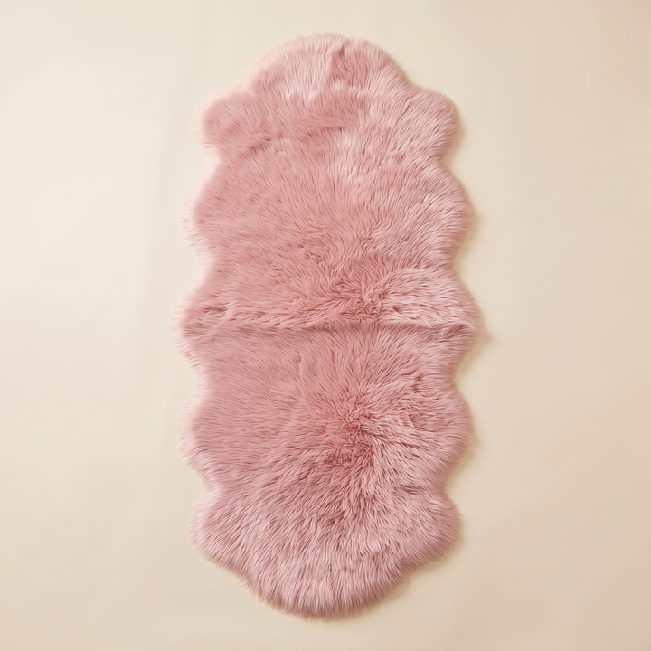 Shaggy Faux Sheepskin Rug in Pink – laid flat on a plain cream background, seen from above
