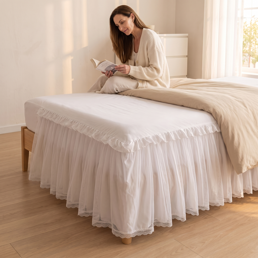 Fitted Ruffled Bed Skirt – Lace Trim in White – woman sitting on the bed reading a book in sunlight
