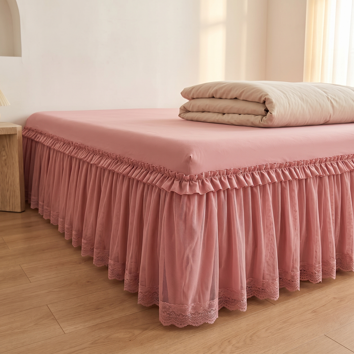 Fitted Ruffled Bed Skirt – Lace Trim in Rose – angled corner view beside wooden nightstand, sunlit curtains behind