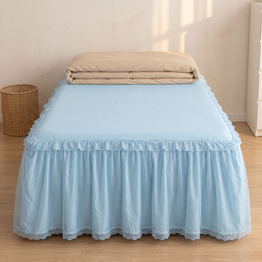 Fitted Ruffled Bed Skirt – Lace Trim in Light Blue – straight-on front view with folded quilt on top, wicker basket beside