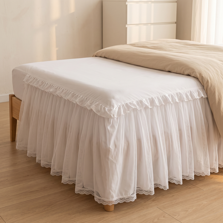 Fitted Ruffled Bed Skirt – Lace Trim in White – on a bed with beige duvet, wooden frame, bright bedroom